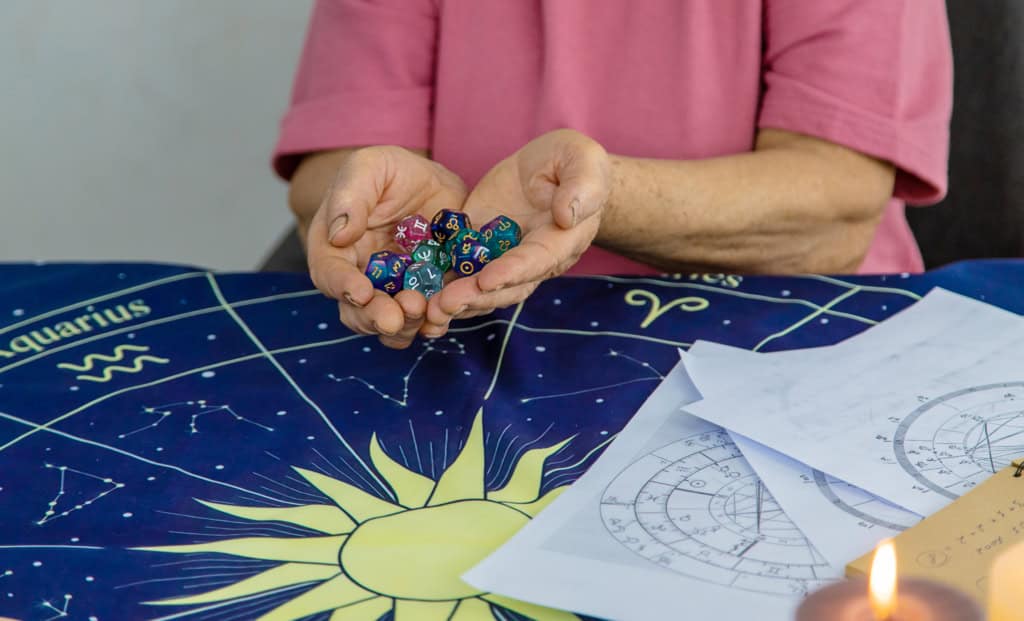 Woman numerologist astrologer counts numbers. Selective focus. People.