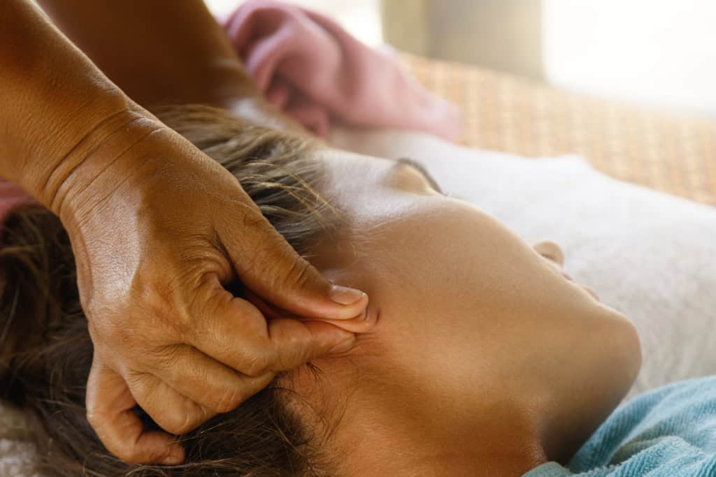 Caucasian woman during traditional Thai massage